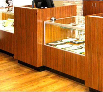 Dark Bamboo Counter with Showcase & 2 POS Stands. View 1 This modern style counter was designed for an upscale surf shop. It includes a dark Bamboo Kane Laminate and a center glass showcase. This simple design can be made in nearly any color or size to give your shop a one of a kind look. Call us to discuss your new counter!