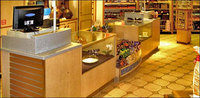 Maple Laminate Showcase Counter with Center Product Display. The center section of this counter is great for stores that sell small gift items or candy because it allows the store owner to sell additional last minute items.