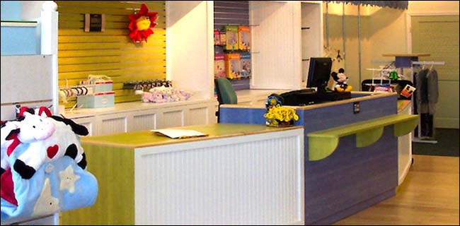 Multi-Colored Angled Kids Store Counter This style counter is great for kids store environments. The colors make it look interesting and the breadboard adds a Cape Cod look. This design is only limited by your imagination.