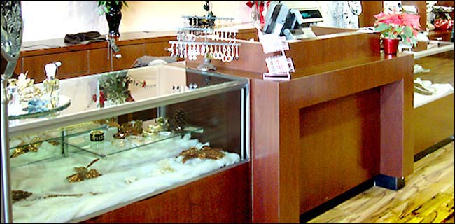 Dark Mahogany Laminate Showcase Counter with Inset Front Panel The inlayed front panel gives the counter a distinct look and creates a design detail that can be carried thought the store. This modern style counter can be made in any size & color allowing us to match your store concept.