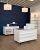 The Moderne register counter features a sturdy, white high-gloss finish and a glass top for an attractive display area. The mobility of the counter is enhanced with casters that make moving it around your space easy and efficient, so you can always keep y