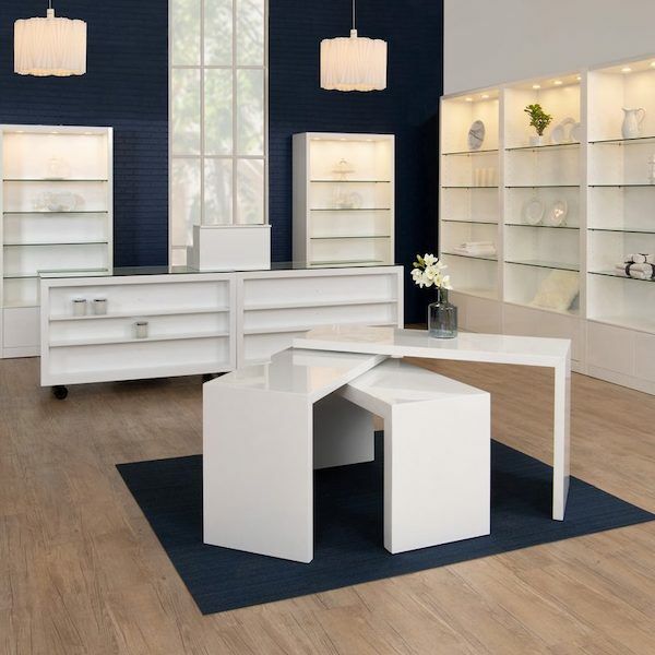 The Moderne swivel table features a glossy white finish and three levels of shelving. Dimensions : 65" L x 28" D x 38" H